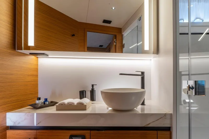  Yacht Photos Pics Luxurious bathroom interior of 2026 Solaris Power 60 yacht with modern fixtures and elegant design.