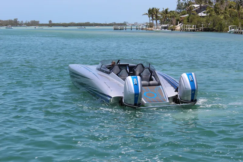  Yacht Photos Pics 2025 Fountain 34 Thundercat speedboat cruising on clear blue water.