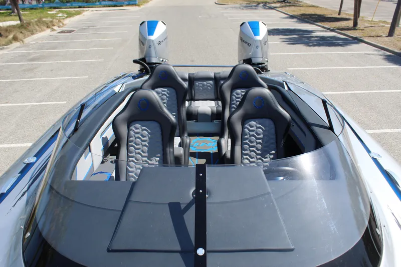  Yacht Photos Pics 2025 Fountain 34 Thundercat boat with sleek design and dual engines in a parking area.