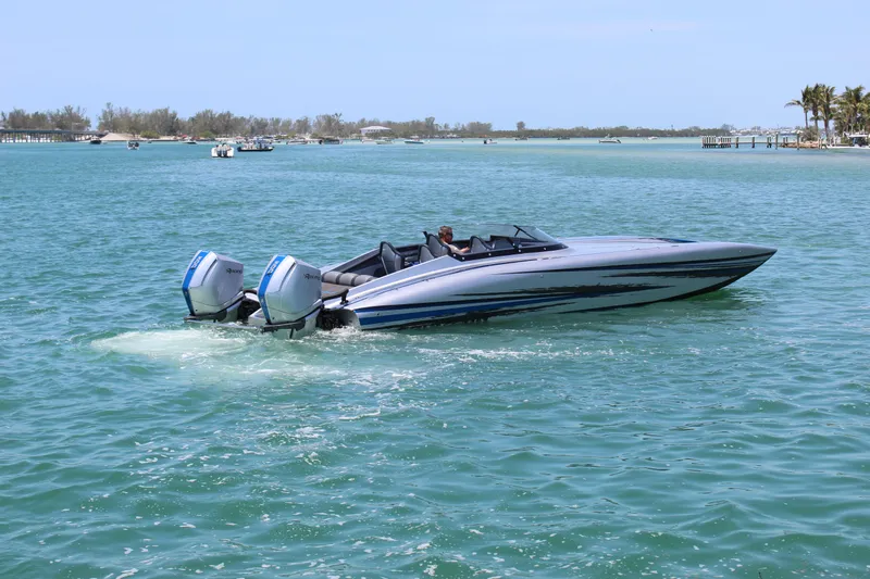  Yacht Photos Pics 2025 Fountain 34 Thundercat speedboat cruising on clear blue water.