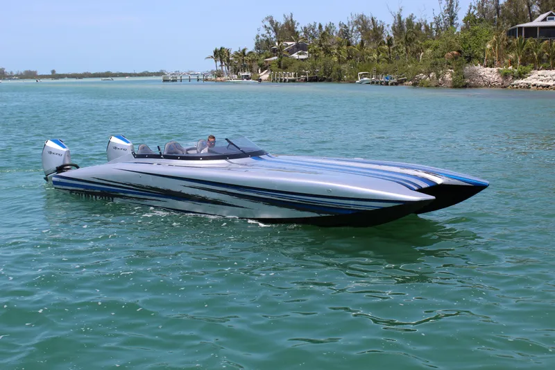  Yacht Photos Pics 2025 Fountain 34 Thundercat speedboat cruising on clear blue water.