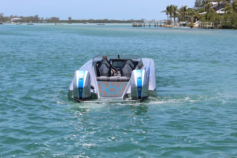  Yacht Photos Pics 2025 Fountain 34 Thundercat powerboat cruising on a sunny, tropical waterway.