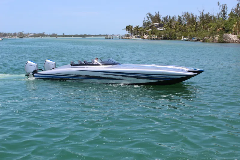  Yacht Photos Pics 2025 Fountain 34 Thundercat speedboat cruising on clear blue water.