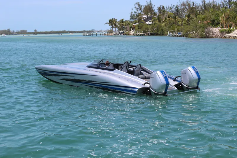  Yacht Photos Pics 2025 Fountain 34 Thundercat speedboat cruising on clear blue water.