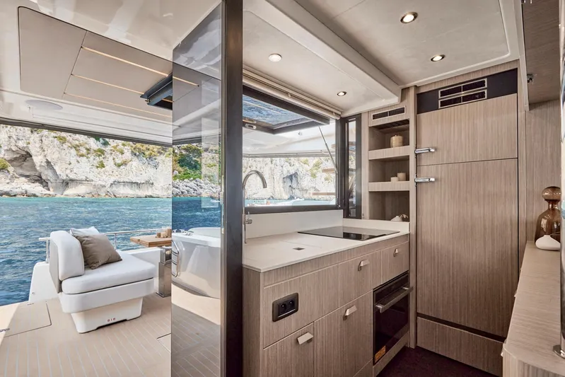  Yacht Photos Pics Luxurious interior of 2025 Prestige F 4.9 yacht with modern kitchen and scenic ocean view.