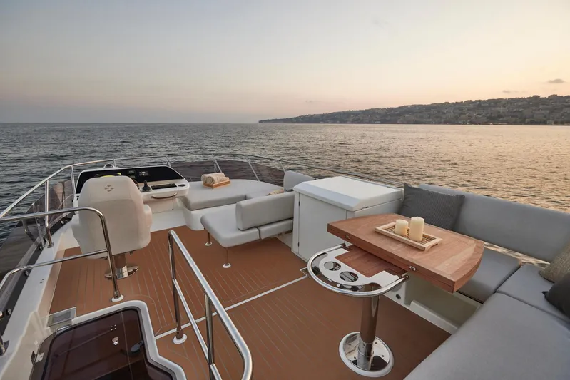  Yacht Photos Pics Luxurious 2025 Prestige F 4.9 yacht deck with elegant seating, ocean view at sunset.