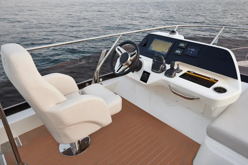  Yacht Photos Pics Luxurious 2025 Prestige F 4.9 yacht helm with modern controls and ocean view.