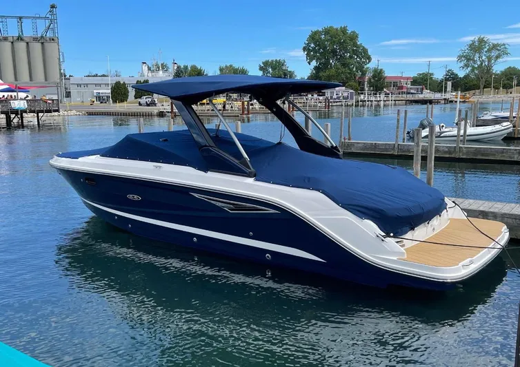  Yacht Photos Pics 2022 Sea Ray SLX 280 boat docked, covered in blue, with scenic marina backdrop.