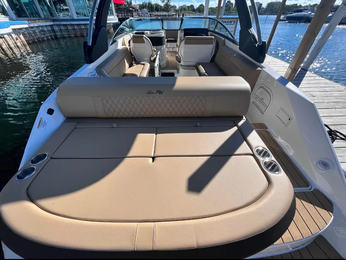  Yacht Photos Pics 2022 Sea Ray SLX 280 boat with spacious seating, docked by the water.