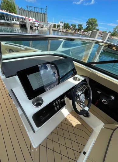  Yacht Photos Pics 2022 Sea Ray SLX 280 helm with modern dashboard and steering wheel, dockside view.
