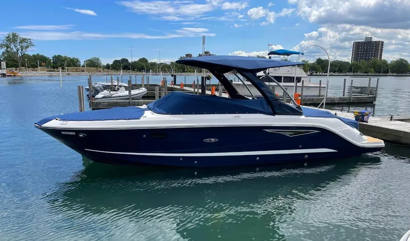  Yacht Photos Pics 2022 Sea Ray SLX 280 boat docked in a marina under a blue sky.