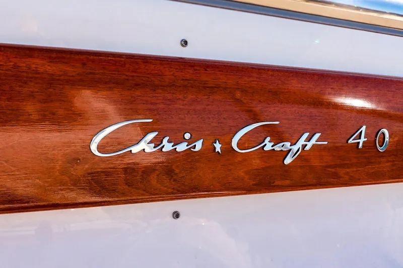 Aphrodite Yacht Photos Pics 2004 Chris-Craft Roamer 40 boat logo on polished wood panel.