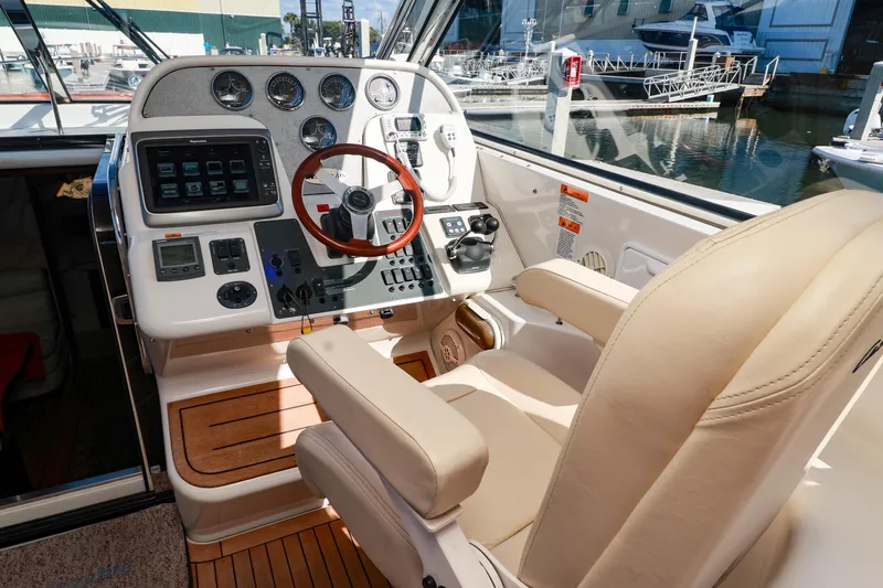Aphrodite Yacht Photos Pics Helm of 2004 Chris-Craft Roamer 40 yacht with leather seat and modern controls.