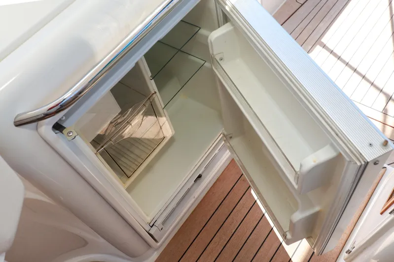 Aphrodite Yacht Photos Pics Open refrigerator on 2004 Chris-Craft Roamer 40 yacht, showcasing interior shelves and door storage.