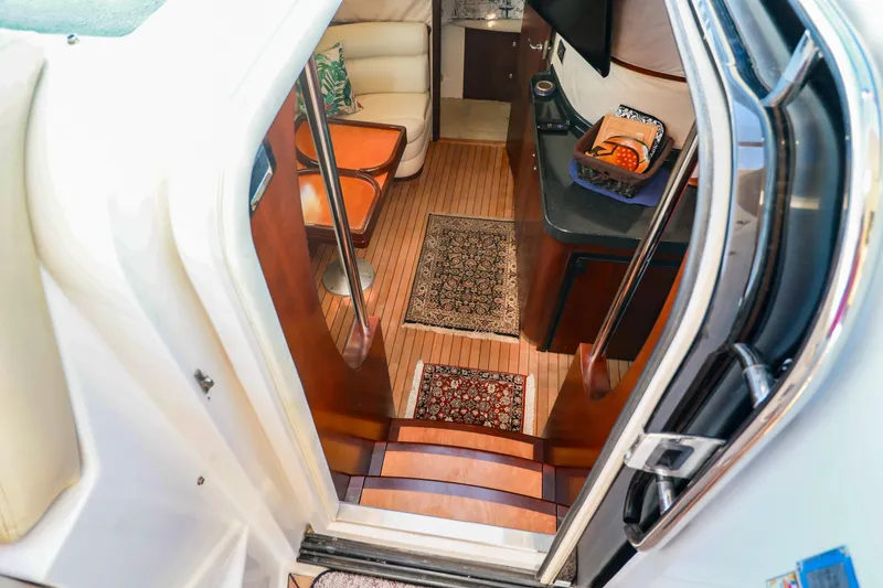 Aphrodite Yacht Photos Pics Interior view of 2004 Chris-Craft Roamer 40 yacht, featuring elegant wood flooring and cozy seating.