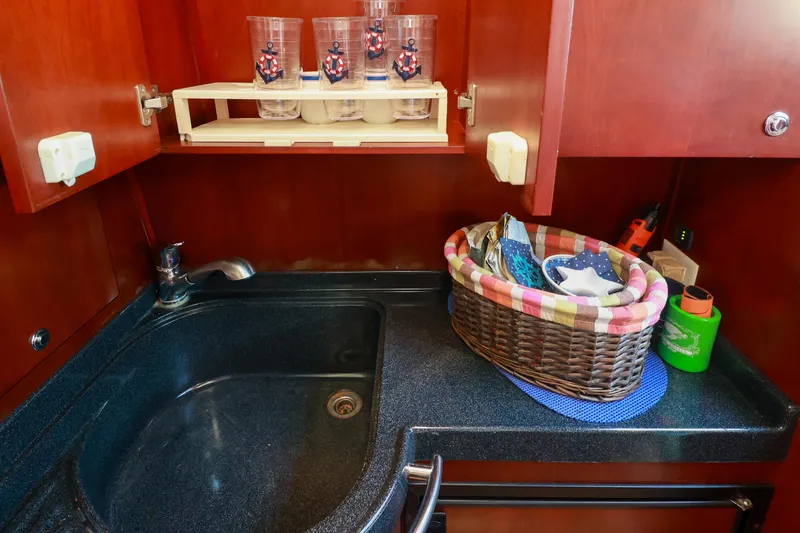 Aphrodite Yacht Photos Pics Luxurious 2004 Chris-Craft Roamer 40 yacht kitchen with sink and storage basket.