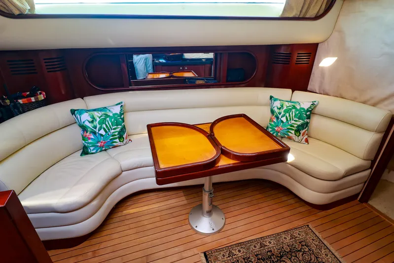 Aphrodite Yacht Photos Pics Luxurious interior of 2004 Chris-Craft Roamer 40 yacht with curved seating and tropical cushions.