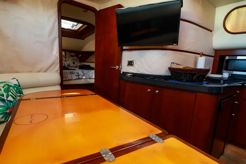 Aphrodite Yacht Photos Pics Luxurious interior of 2004 Chris-Craft Roamer 40 yacht with modern amenities and elegant wood finishes.