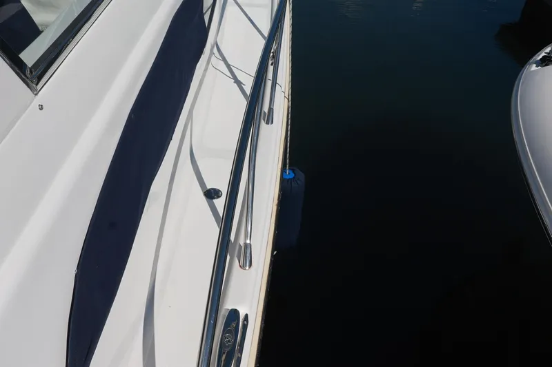 Aphrodite Yacht Photos Pics 2004 Chris-Craft Roamer 40 yacht side view with railing and water reflection.