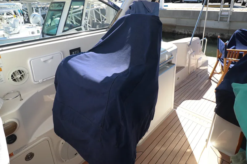 Aphrodite Yacht Photos Pics 2004 Chris-Craft Roamer 40 boat interior with covered seating and wooden deck.