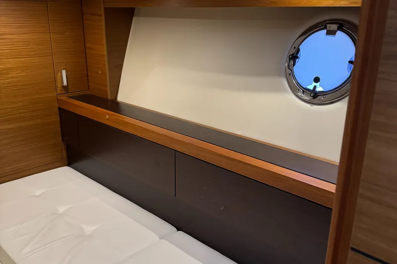 After Glow Yacht Photos Pics Interior cabin of 2016 Tiara Yachts 39 Coupe with porthole and wooden accents.