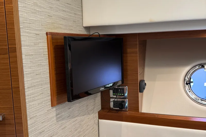 After Glow Yacht Photos Pics 2016 Tiara Yachts 39 Coupe interior with mounted TV and porthole.