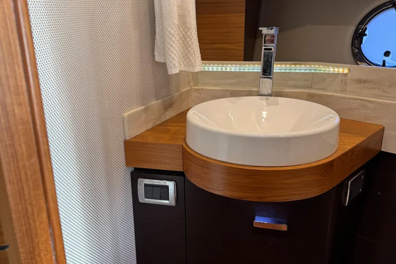 After Glow Yacht Photos Pics Luxurious bathroom sink in 2016 Tiara Yachts 39 Coupe, featuring modern design and wood accents.