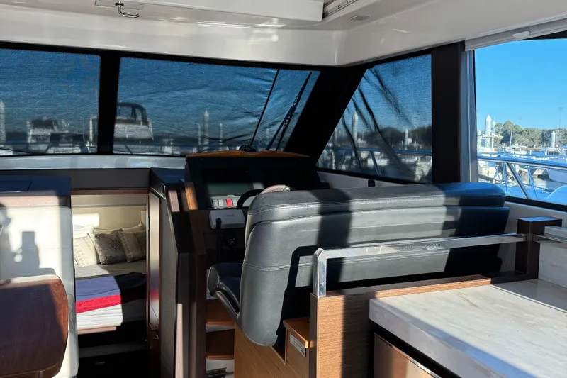 After Glow Yacht Photos Pics Interior of 2016 Tiara Yachts 39 Coupe, featuring helm and cabin area.