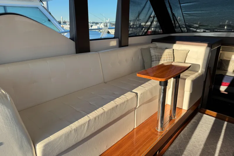 After Glow Yacht Photos Pics Luxurious interior of 2016 Tiara Yachts 39 Coupe with elegant seating and wooden table.