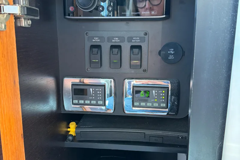 After Glow Yacht Photos Pics Control panel of a 2016 Tiara Yachts 39 Coupe, featuring switches and digital displays.