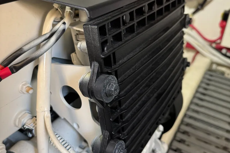 After Glow Yacht Photos Pics Close-up of 2016 Tiara Yachts 39 Coupe engine component with wiring and black grille.