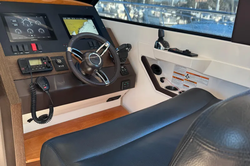 After Glow Yacht Photos Pics Interior helm of 2016 Tiara Yachts 39 Coupe with modern controls and navigation displays.