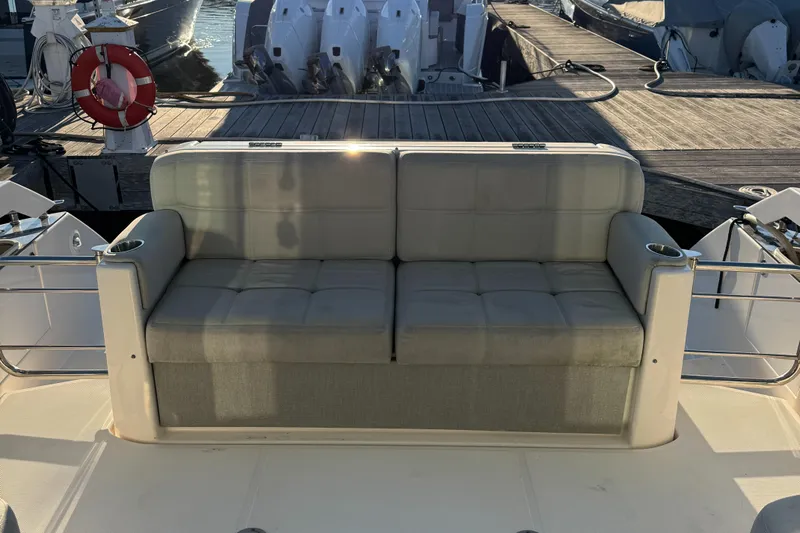 After Glow Yacht Photos Pics Tiara Yachts 2016 39 Coupe with cushioned seating on deck, docked at marina.