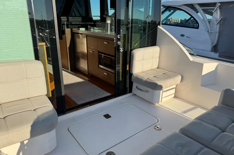 After Glow Yacht Photos Pics 2016 Tiara Yachts 39 Coupe interior with seating and kitchen view.