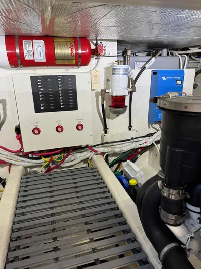 After Glow Yacht Photos Pics Engine room of 2016 Tiara Yachts 39 Coupe with control panel and fire extinguisher.