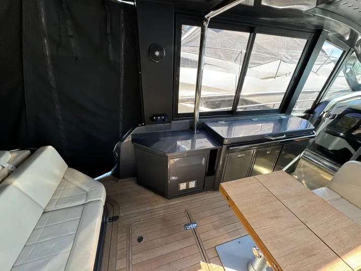 Anahita Yacht Photos Pics Interior of 2017 SACS Rebel 47 yacht with seating, table, and kitchenette.