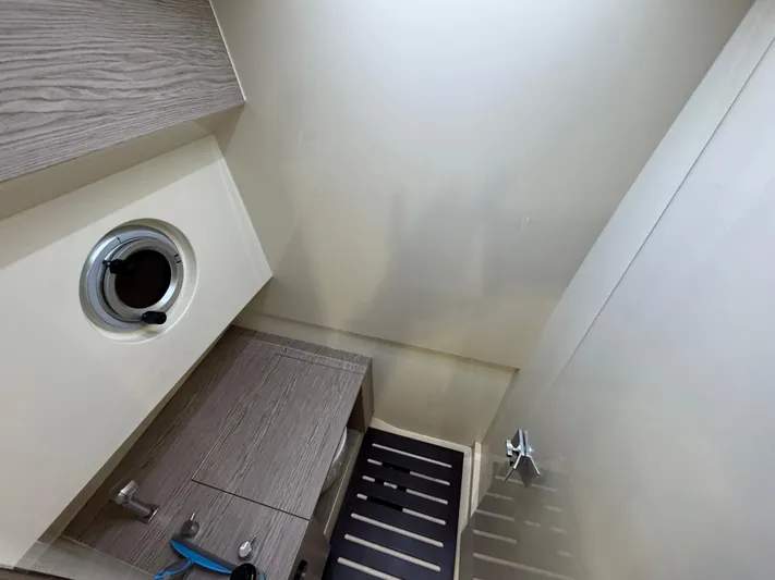 Anahita Yacht Photos Pics Interior of 2017 SACS Rebel 47 yacht bathroom with modern fixtures and porthole window.