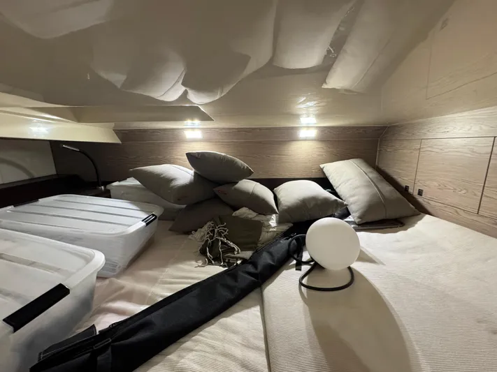 Anahita Yacht Photos Pics Cozy cabin interior of 2017 SACS Rebel 47 with pillows and storage containers.