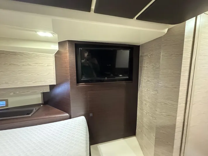Anahita Yacht Photos Pics Interior of 2017 SACS Rebel 47 yacht with modern TV and sleek wood paneling.