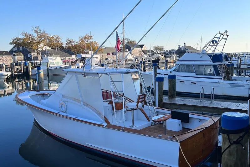 Charmer Yacht Photos Pics 1985 Rybovich Walkaround boat docked at a marina with other boats.