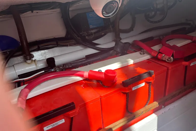 Charmer Yacht Photos Pics 1985 Rybovich Walkaround boat battery compartment with red battery cables.