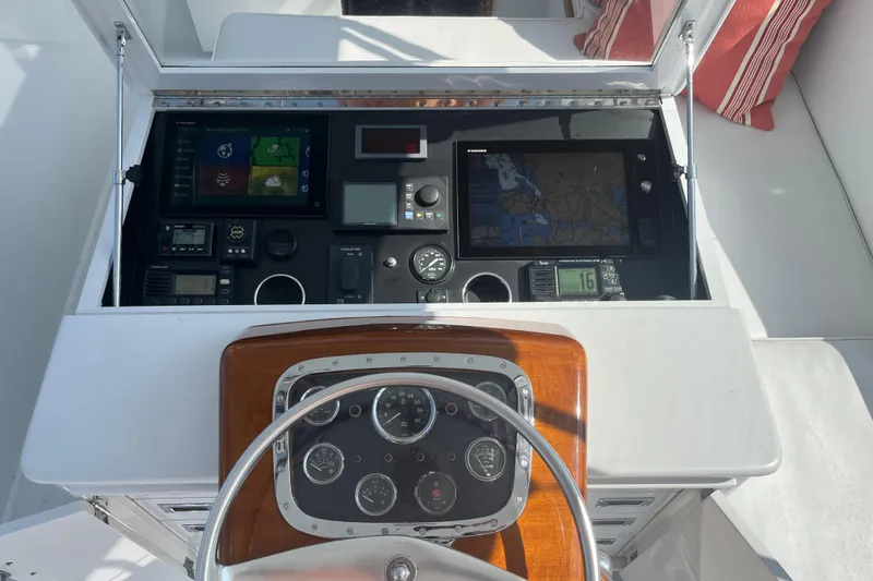 Charmer Yacht Photos Pics 1985 Rybovich Walkaround boat dashboard with navigation and control instruments.