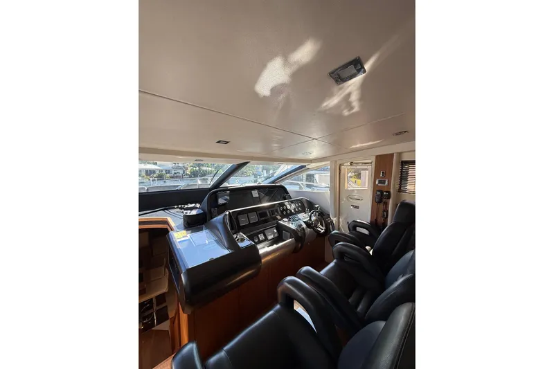 Jimbo Yacht Photos Pics Interior cockpit of 2012 Sunseeker Predator Sport Yacht 74, featuring sleek controls and seating.