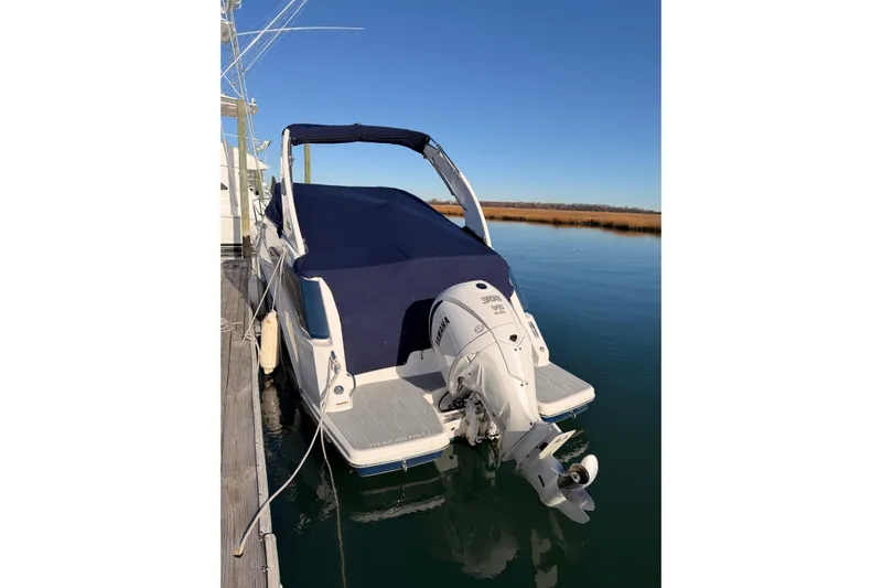  Yacht Photos Pics 2022 Regal 26 XO boat with Yamaha engine docked on calm water.