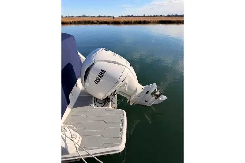  Yacht Photos Pics 2022 Regal 26 XO boat with Yamaha outboard motor on calm water.