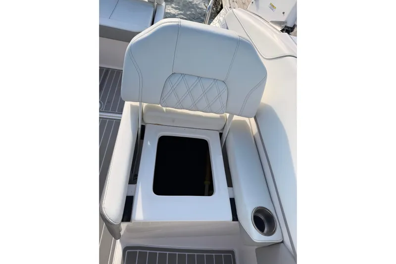  Yacht Photos Pics 2022 Regal 26 XO boat seat with storage compartment and cup holder.