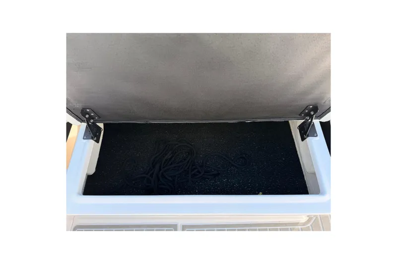  Yacht Photos Pics Open storage compartment in 2022 Regal 26 XO boat, containing coiled rope.