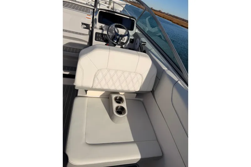  Yacht Photos Pics 2022 Regal 26 XO boat interior with white seating and steering wheel.