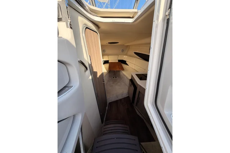  Yacht Photos Pics Interior view of 2022 Regal 26 XO boat cabin with seating and table.