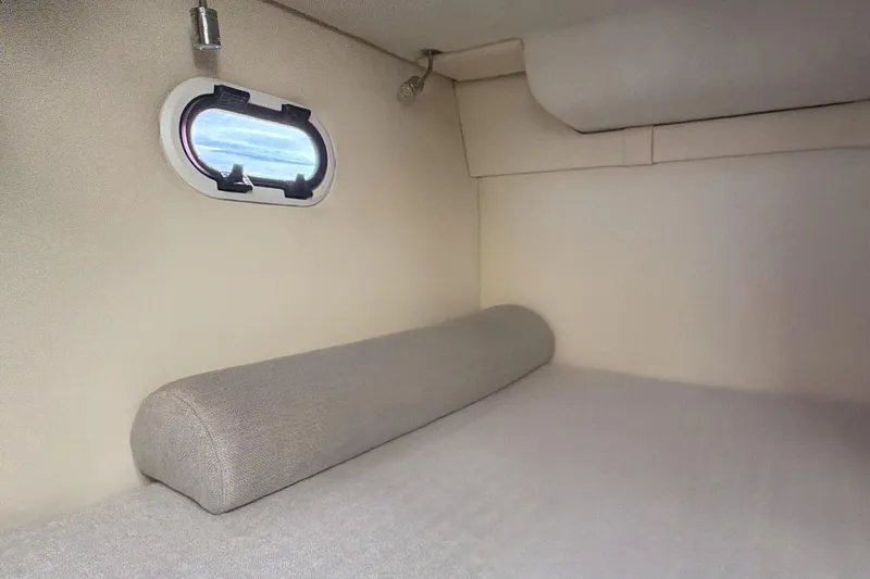  Yacht Photos Pics Interior cabin of 2022 Regal 26 XO boat with window and cushioned seating.